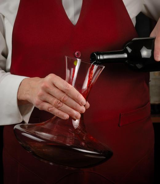 Wine is poured into a decanter to allow the beverage to breathe.