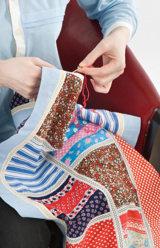 Some hand quilters quilt in their laps.