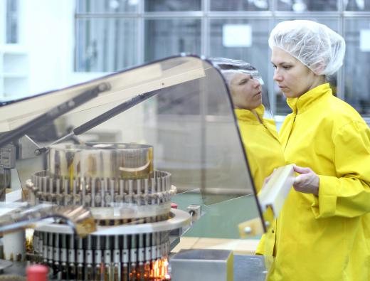 Quality control employees inspect milling equipment for irregularities that could damage products.