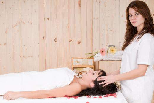 Unified field therapy sessions are conducted in a private room with the client lying face up on a massage table.