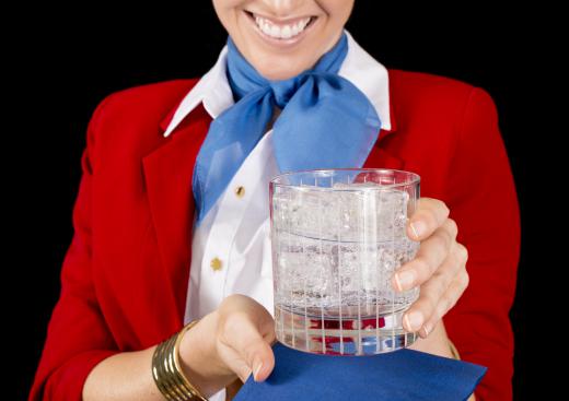 An airline stewardess is responsible for serving drinks during a flight.