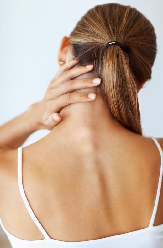 A woman with neck pain and a headache because of a pinched nerve.