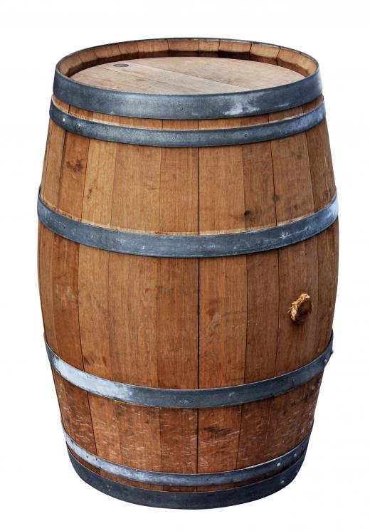 A wooden barrel can be used to collect rain to water an eco-friendly garden.