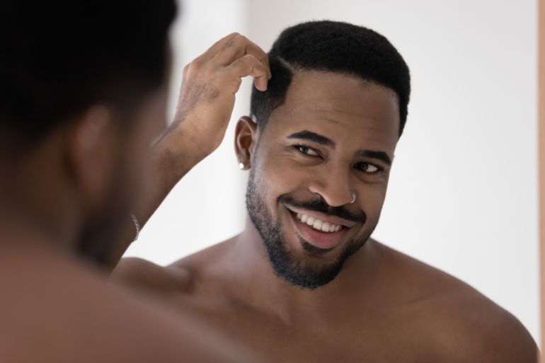 black man moisturizing his hair