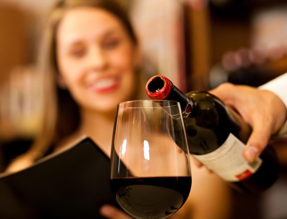 woman-near-glass-of-wine-being-poured.jpg